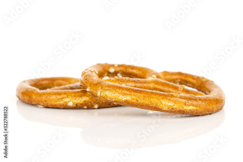 Group of two whole salty brown pretzel isolated on white background