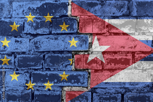 European Union and Cuba flag on a brick wall photo