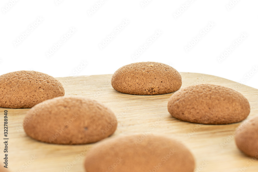Group of five whole sweet brown chocolate sponge biscuit on bamboo cutting board isolated on white background Group of five whole sweet brown chocolate sponge biscuit on bamboo cutting board isolated on white background