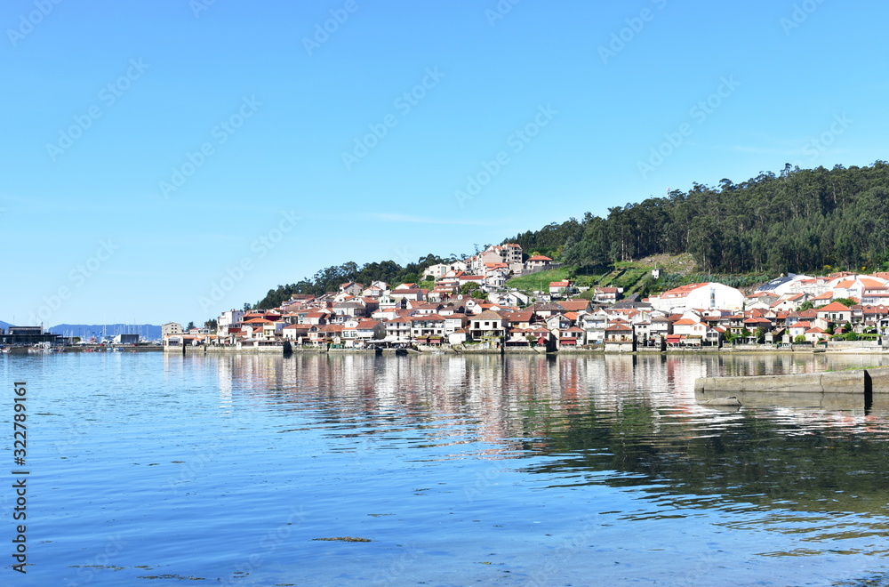 Small fishing village with blue sky and water reflections. Combarro, Rias Baixas, Galicia, Spain.