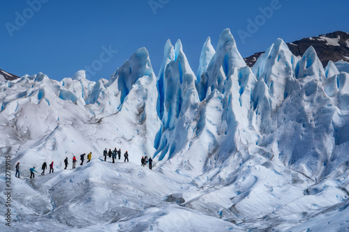 Tourists Trekking on Perito Moreno Glacier in Los Glaciares National Park Near El Calafate in Argentina, Patagonia, South America photo