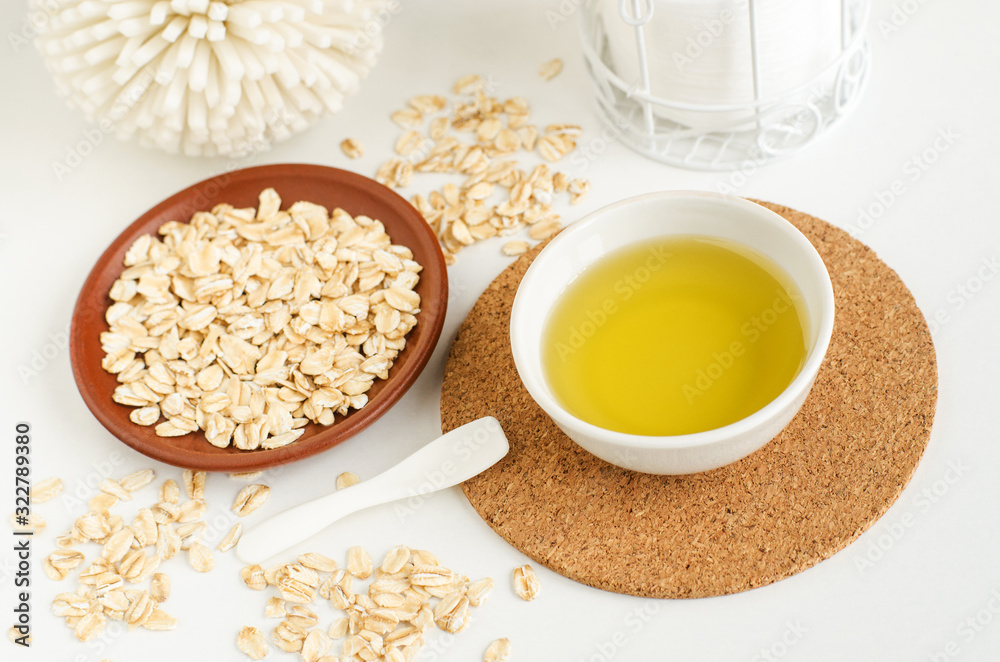 Small white bowl with olive oil and oatmeal. Homemade skin and hair  treatment and zero waste concept. Copy space Stock Photo | Adobe Stock