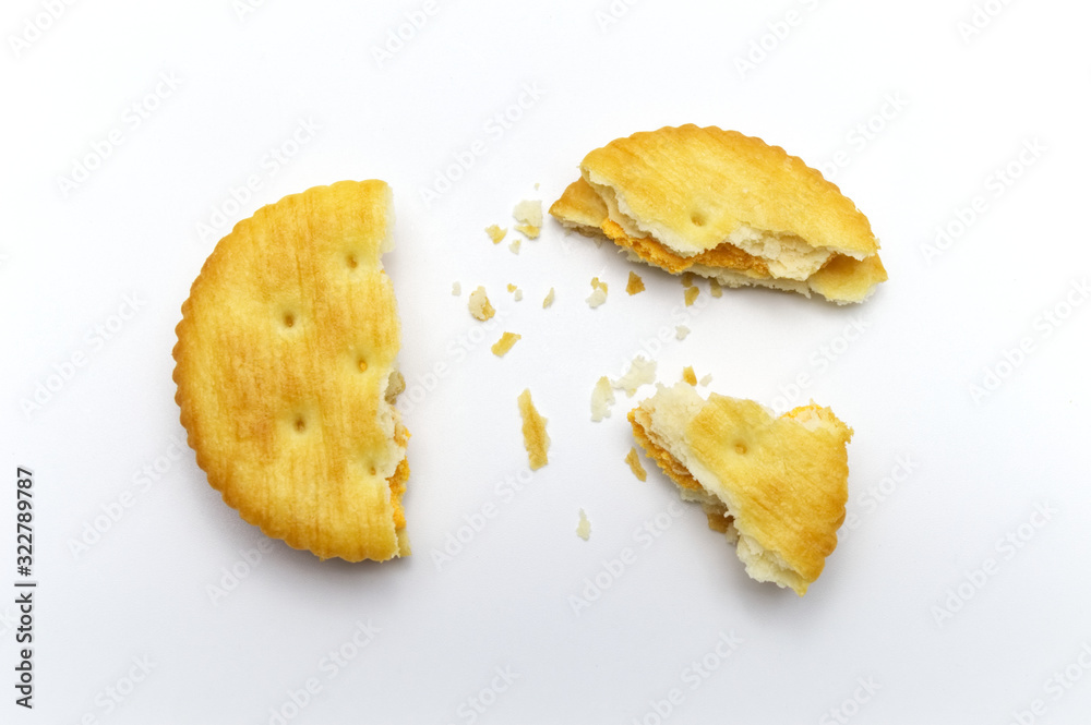 Biscuit and crumbs of sandwich cracker Cheese flavoured ,Cream and butter. Crunchy delicious sweet meal and useful cookies. On white background. Biscuit and crumbs of sandwich cracker Cheese flavoured ,Cream and butter. Crunchy delicious sweet meal and useful cookies. On white background.