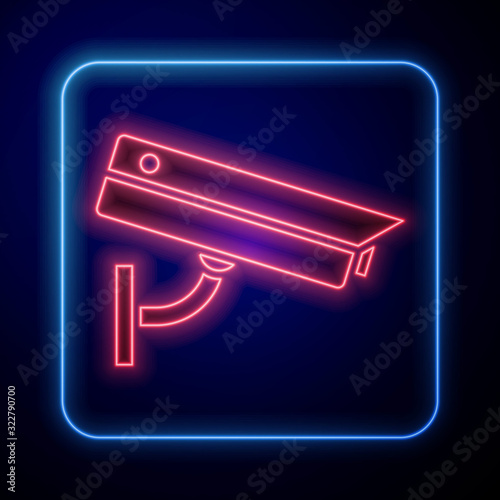 Glowing neon Security camera icon isolated on blue background.  Vector Illustration