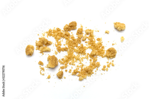 Scattered crumbs of butter cookies on white background.