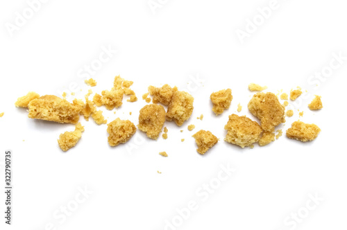 Scattered crumbs of butter cookies on white background.