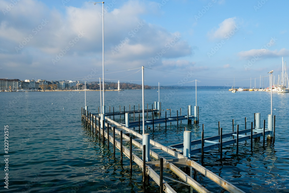 Geneva / Switzerland - december 20 2019 : pontoon and quay on Lake Geneva opposite the water jet