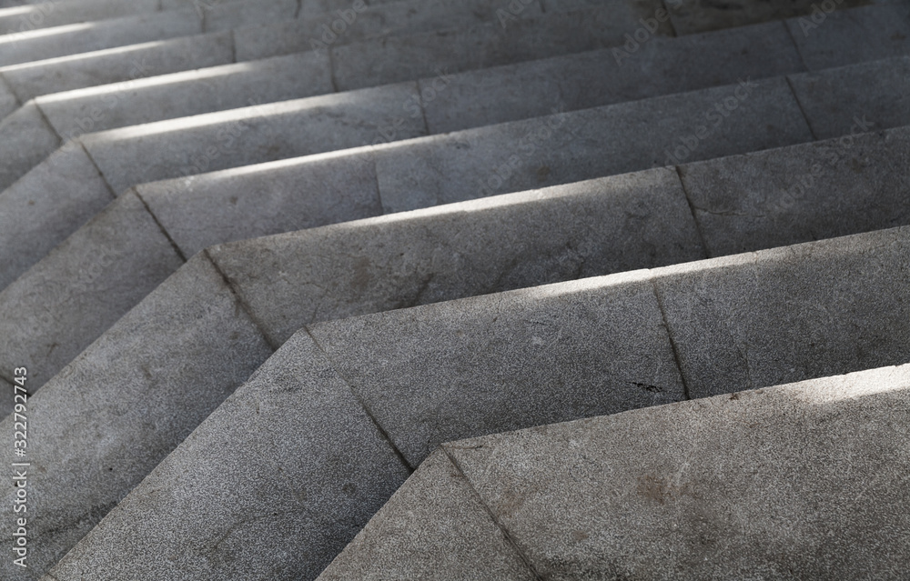 Empty stone stairs with bright sunlight pattern