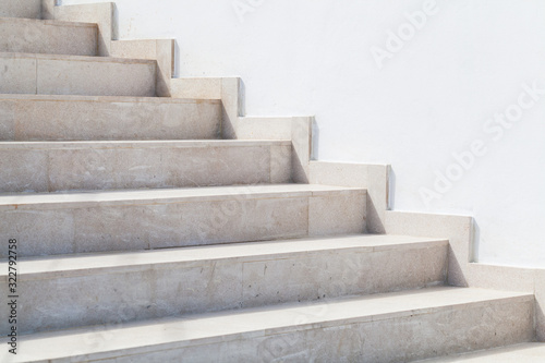Empty stone stairway near white wall, abstract photo photo