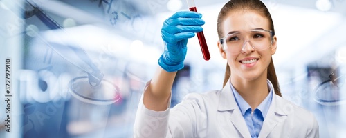 A young female scientist with a test tube photo