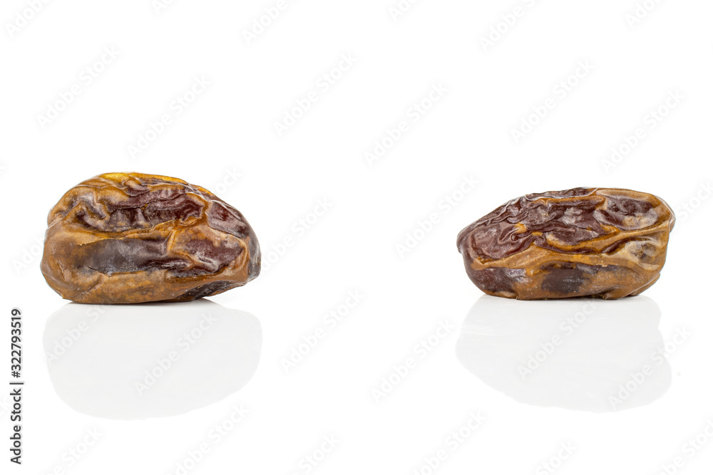 Group of two whole dry brown date fruit isolated on white background Group of two whole dry brown date fruit isolated on white background