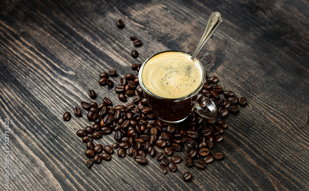 Coffee cup espresso and beans on a wooden background. breakfast concept, italian coffee Coffee cup espresso and beans on a wooden background. breakfast concept, italian coffee