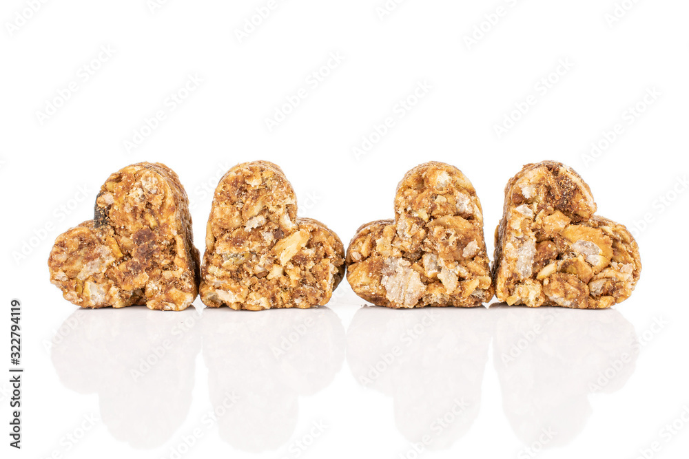 Group of four whole healthy brown cereal heart with cocoa isolated on white background Group of four whole healthy brown cereal heart with cocoa isolated on white background