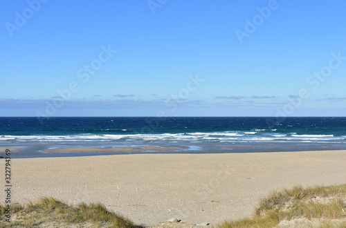 Summer landscape with wild beach with waves breaking and blue sky. Arteixo, Coruña, Galicia, Spain. © JB