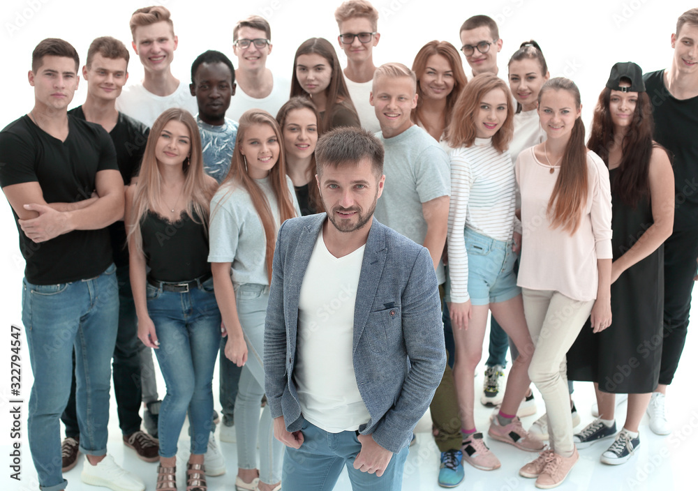 confident guy standing in front of a group of young people