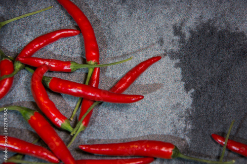 Chili pepper, different types and colors, with copy-space, on gray background