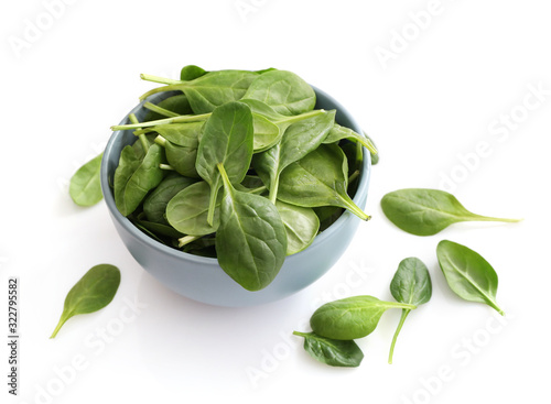 Spinach leaves in bowl isolated on white