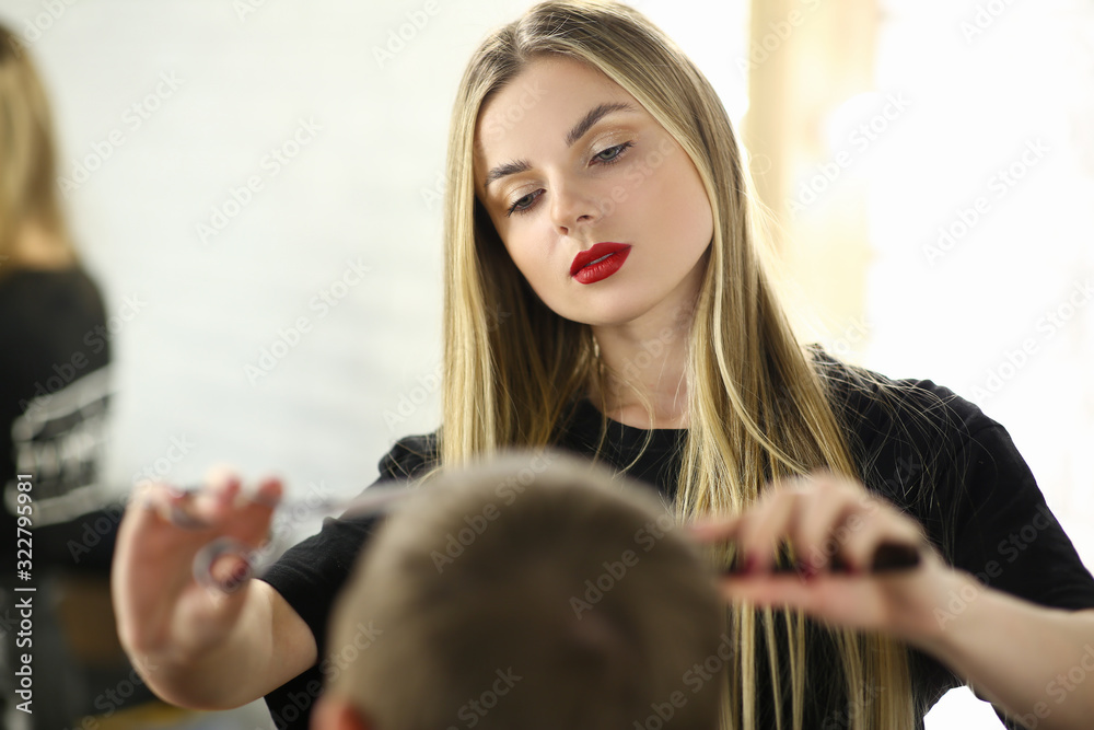 Fototapeta premium Barber Woman Cutting Male Hair in Barbershop Salon. Young Hairdresser Making Haircut to Client. Professional Beautician Styling Hairdo for Customer. Girl Stylist Working in Hairstyle Studio