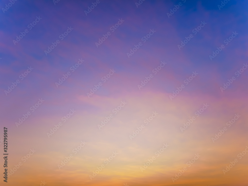 Fantasy twilight dawn blurred abstact background, Gold sunlight on blue sky and moving soft purple clouds before sunset