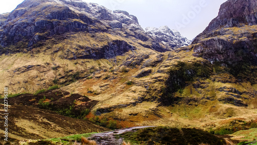 Scotland travel series snow covered mountain range with mossy rocks © VIDEOMUNDUM
