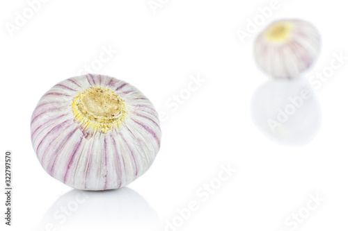 Group of two whole fresh purple single clove garlic isolated on white background