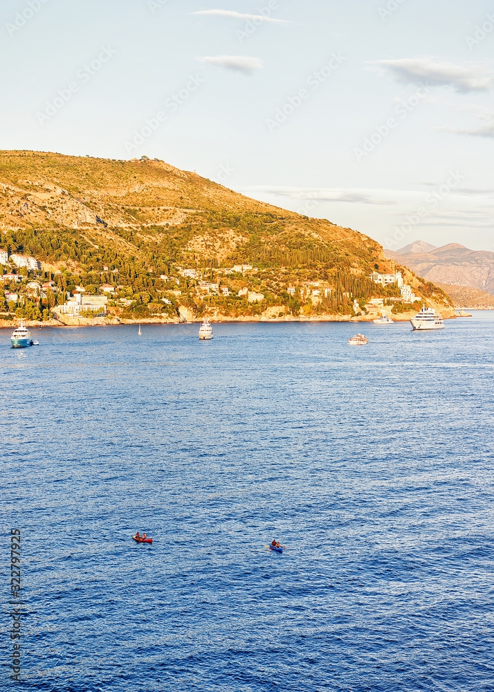 Cruise ships near Dubrovnik coast in Adriatic Sea at sunset