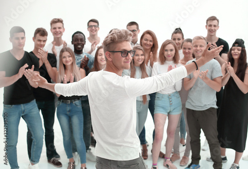 creative group of young people applauding their leader