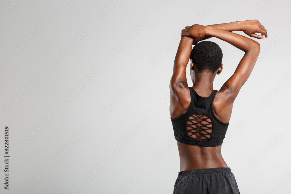 Fototapeta premium Image from back african american woman stretching her arms