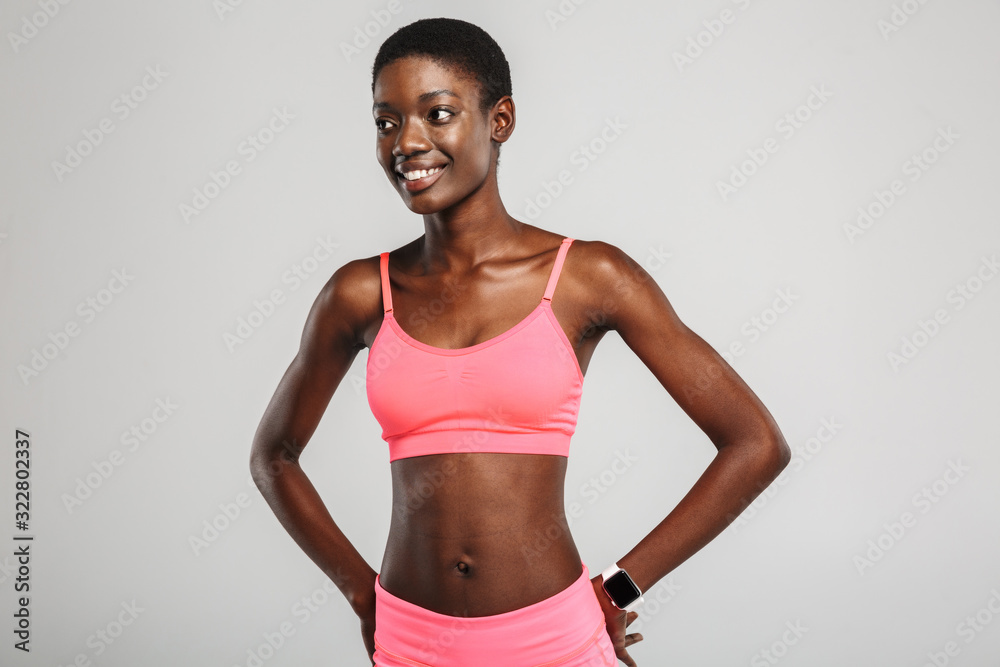 Image of cheerful african american sportswoman posing and smiling