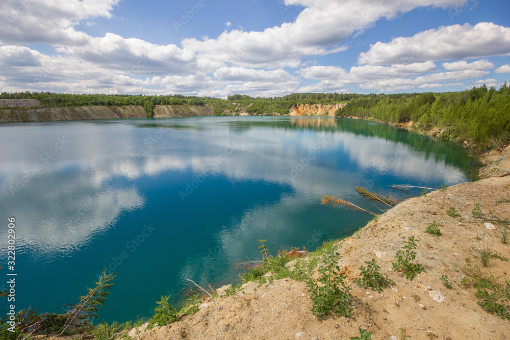 Flooded quarry lake with blue water landscape