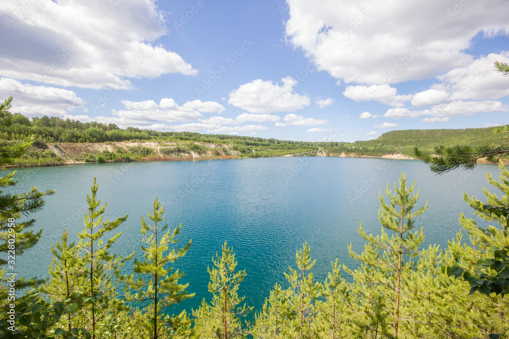 Flooded quarry lake with blue water landscape Flooded quarry lake with blue water landscape