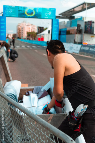 detail of a man working loading tarps and fences