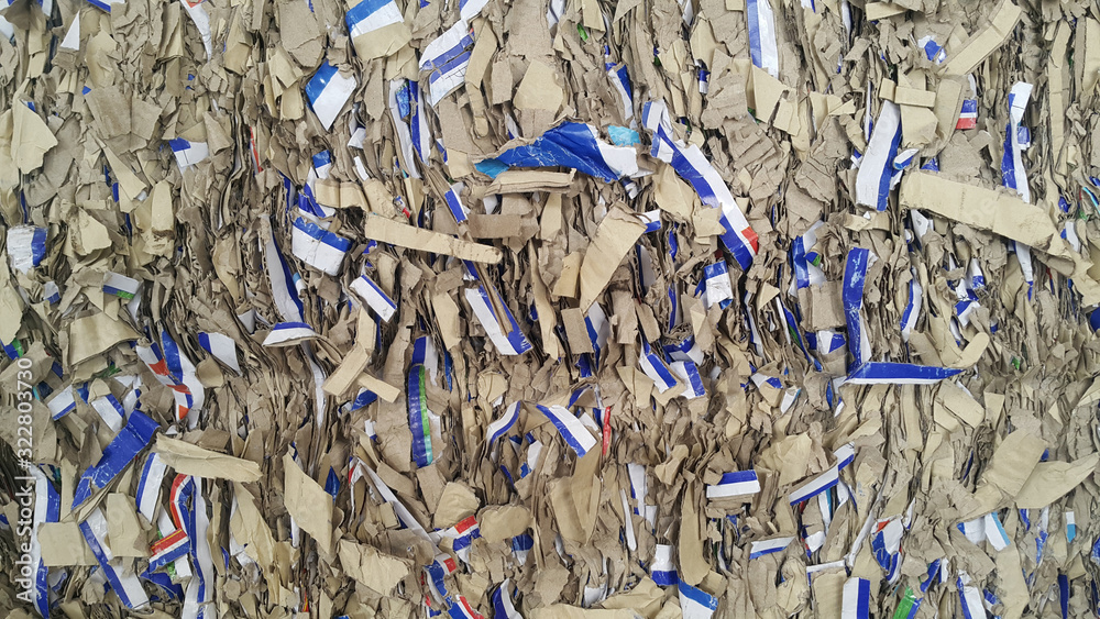 Bales of cardboard and box board. Wastepaper for Recycling. Background of paper textures piled ready to recycle on yard