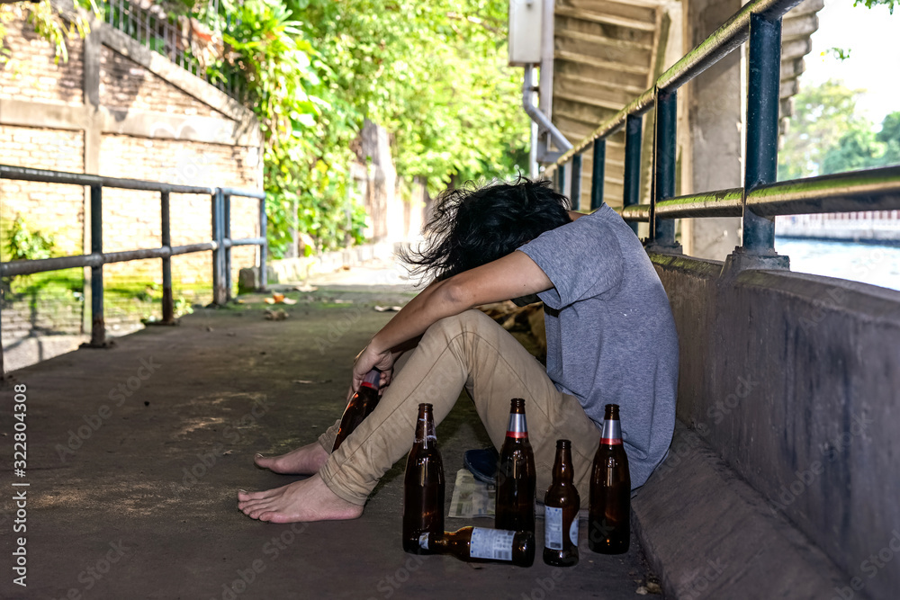 Portrait The man was sadly drinking liquor under the bridge. Portrait The man was sadly drinking liquor under the bridge.