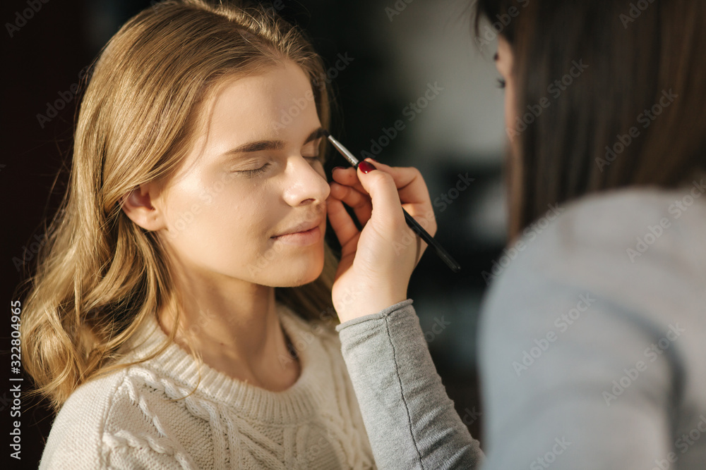 Makeup artist work with model in beauty studio. Start working. Model without makeup. Beautiful makeup artst Makeup artist work with model in beauty studio. Start working. Model without makeup. Beautiful makeup artst