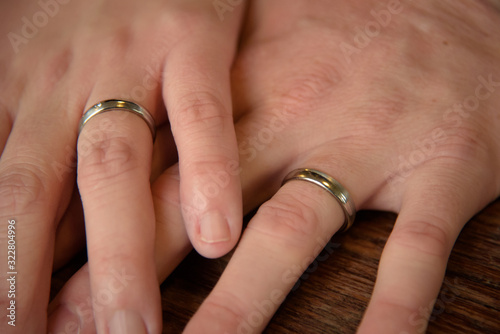 Hands of just married couple with wedding rings