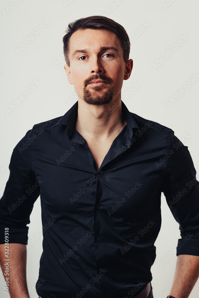 Photo of a handsome man on a bright background in the studio. Vertical photo. The man tries to express his emotions with his expressions. Photo of a handsome man on a bright background in the studio. Vertical photo. The man tries to express his emotions with his expressions.