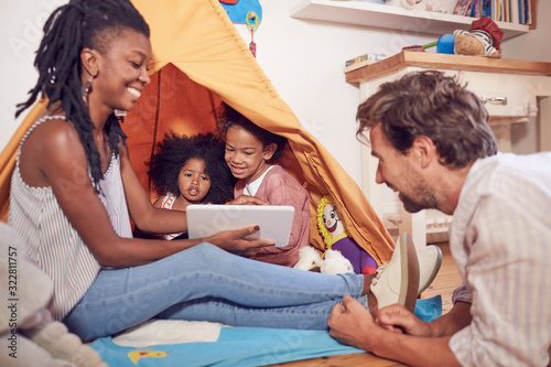 Wallpaper Mural Young family using digital tablet on teepee Torontodigital.ca