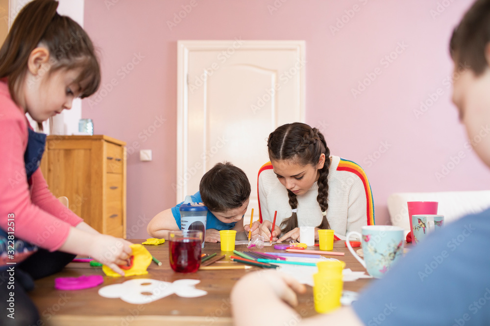 Brothers and sisters coloring at dining table Brothers and sisters coloring at dining table