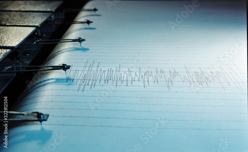 Swinging needle of seismograph at earthquake. photo