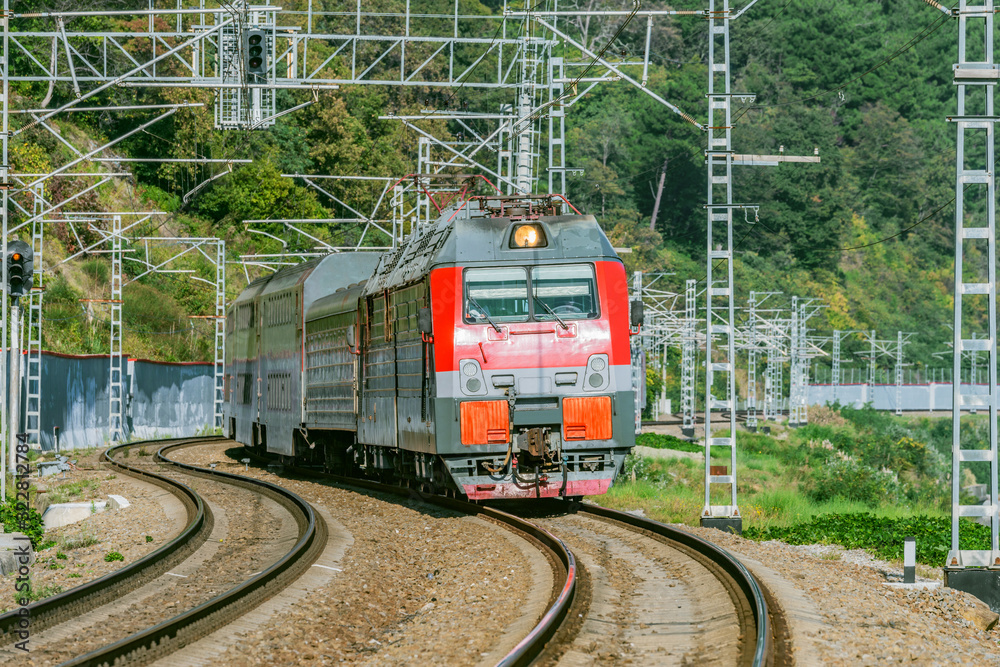 Naklejka premium Passenger double deck train moves along the mountains. Sochi. Russia.