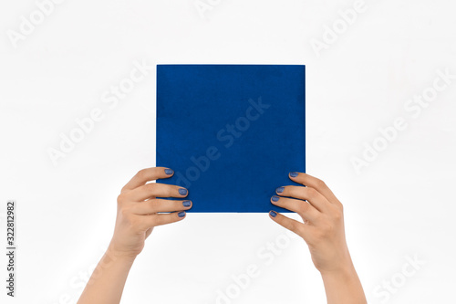 Hands Holding book Sheet isolated on white