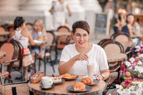 Photography Woman stirs milkshake at table