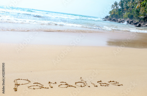 Sand beach of the Indian ocean at Mirissa, Sri Lanka. Hand written words on the beach. Memories of the holiday travel to Ceylon.