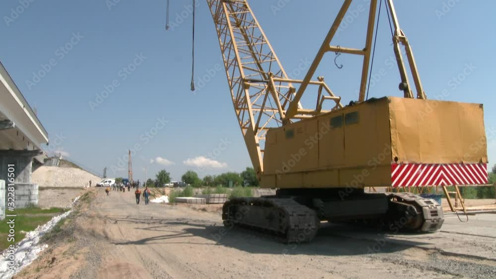 High crane for the construction of reinforced concrete structures and bridges. Workers at a construction site. Construction of a highway among trees through water 4k High crane for the construction of reinforced concrete structures and bridges. Workers at a construction site. Construction of a highway among trees through water 4k