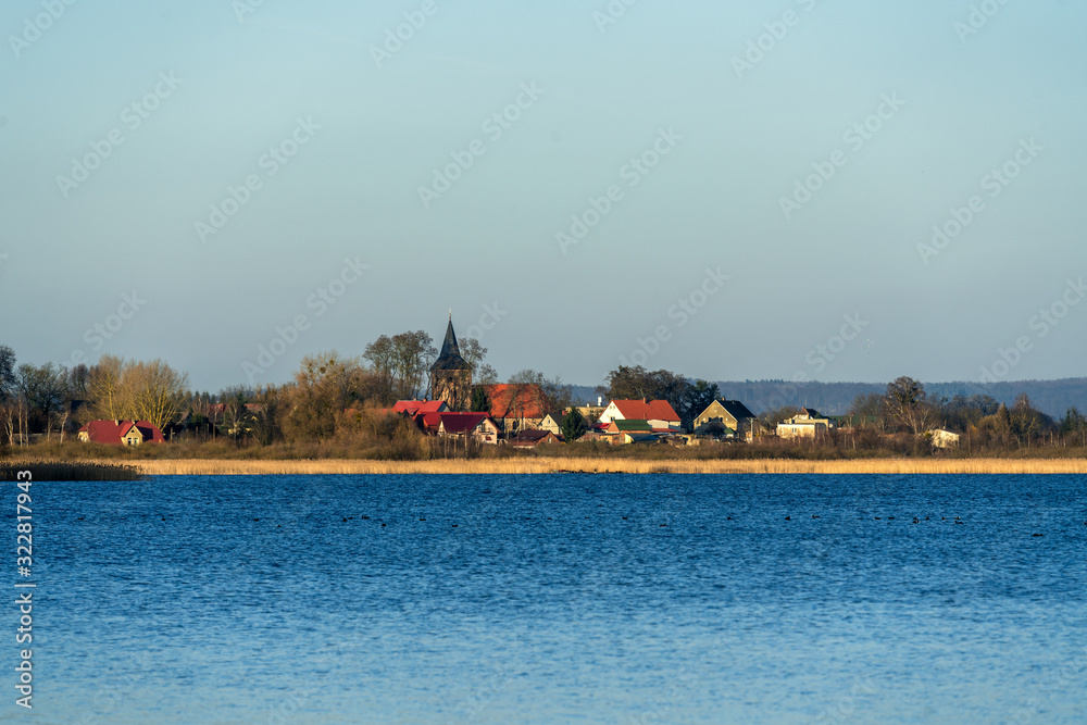 The village Weltyn in Poland seen across the lake The village Weltyn in Poland seen across the lake