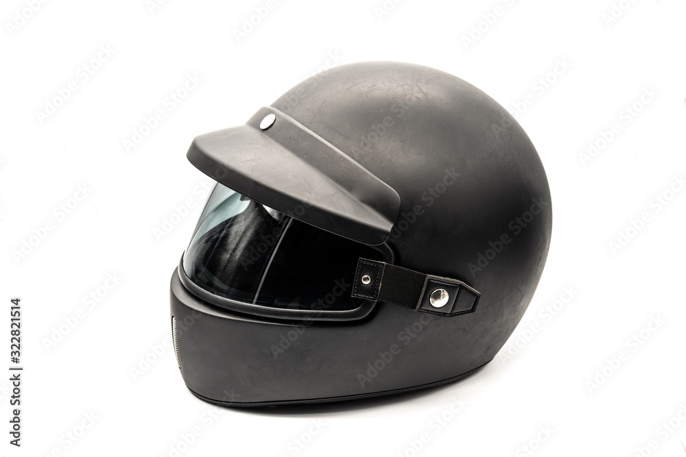 Obraz premium Casco de moto negro y usado sobre fondo blanco