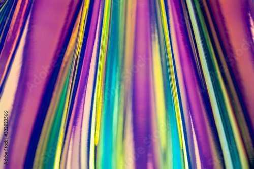 Holographic abstract colorful backdrop. Holographic color wrinkled foil. Iridescent art. Blurred background.