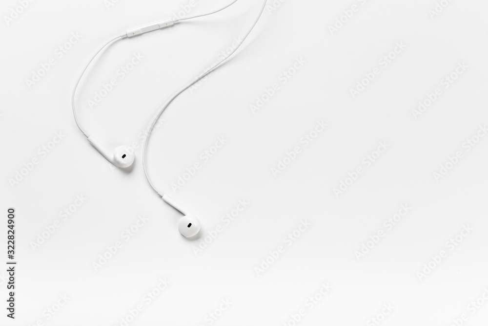 White modern headphones with a headset on a light gray background White modern headphones with a headset on a light gray background