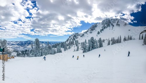 Fotografie Winter mountain landscape of Snowbasin ski resort with skiers on the slopes